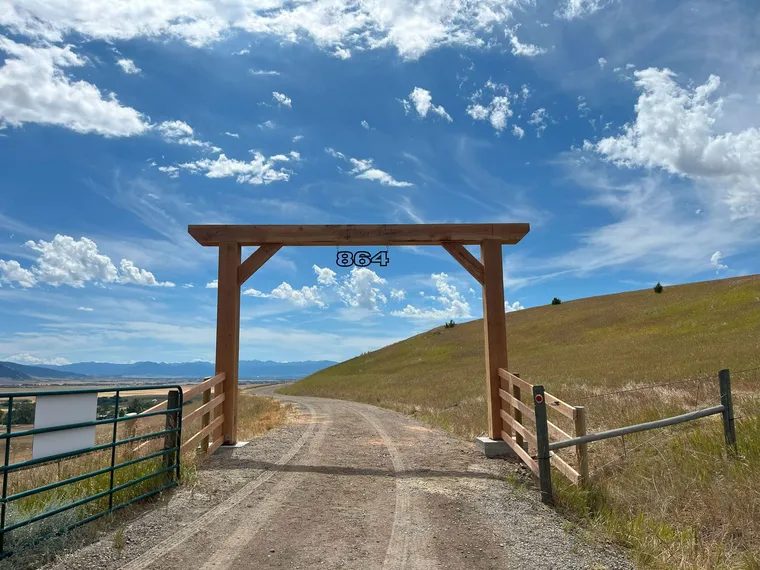 Custom ranch entryway sign on a timber archway built by Montana Ranch & Land Improvement Service