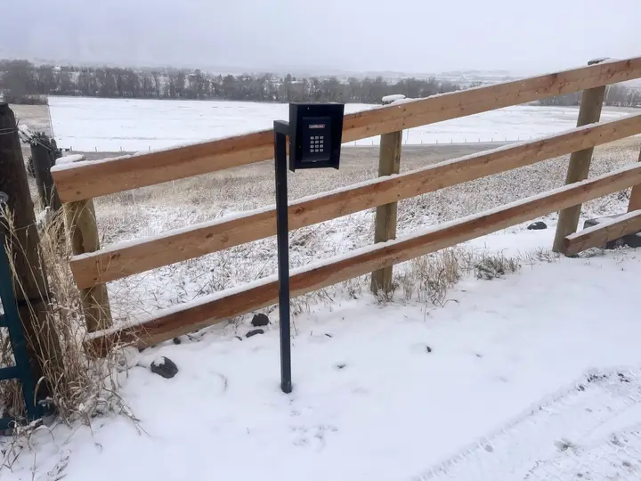 Western entrance archway with automatic gate — built for deep frost and heavy gate loads.