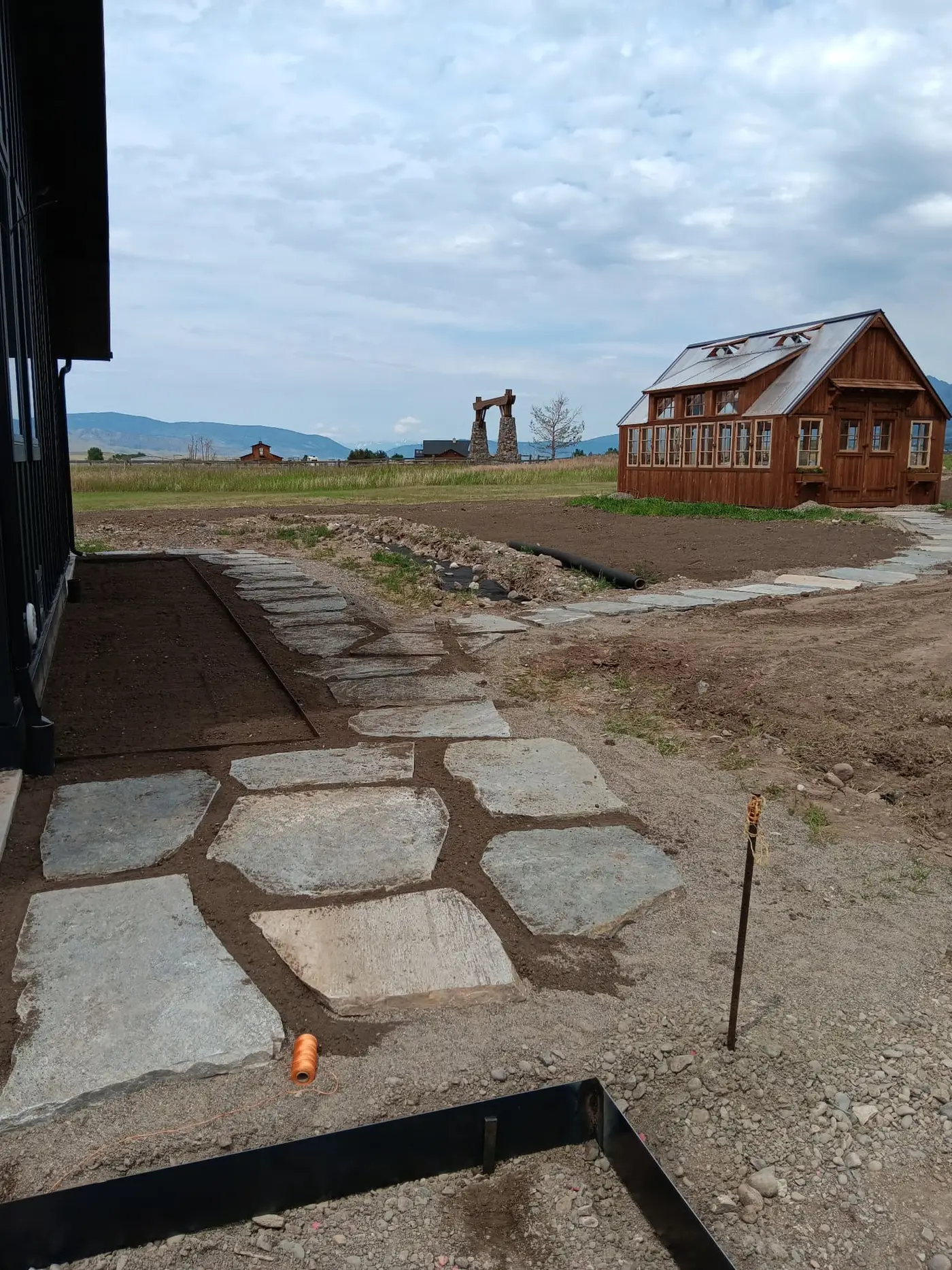 Flagstone walkway being set in a prepared base beside a Montana home