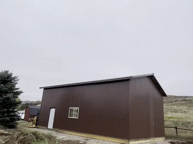 Steel-sided pole barn framing in progress